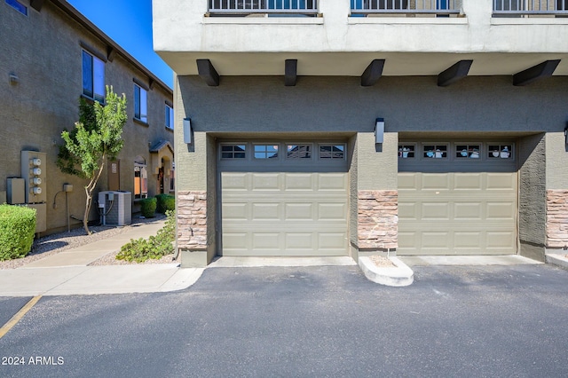 garage featuring driveway and central AC