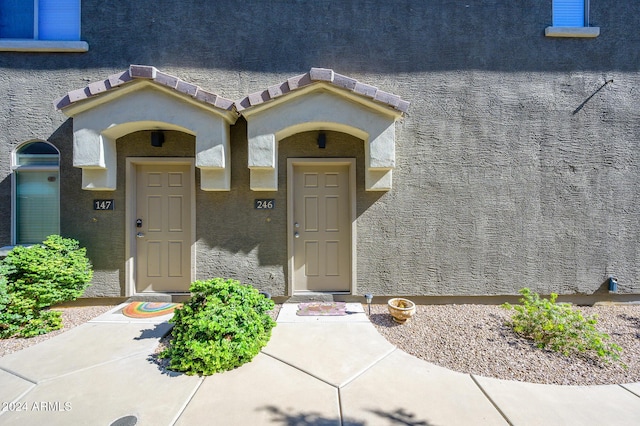 view of exterior entry with stucco siding