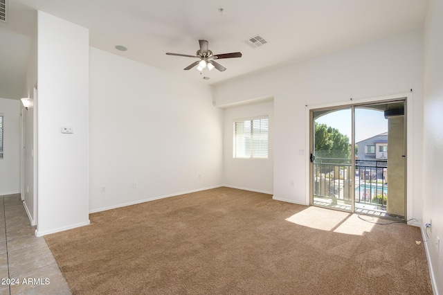 carpeted empty room featuring ceiling fan, baseboards, and visible vents