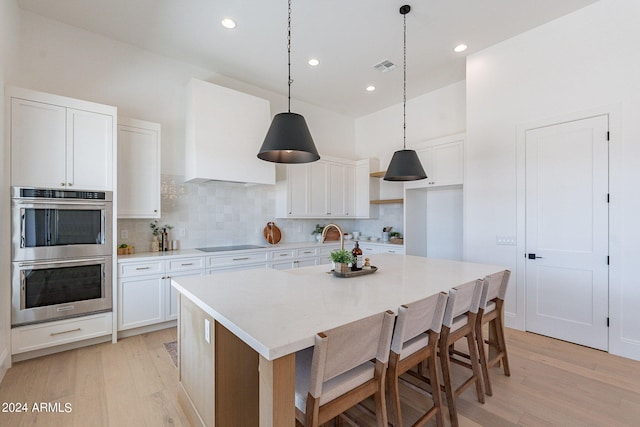 6926 N 177th Pl, Waddell, AZ 85355 - kitchen with stainless steel double oven, light wood-style flooring, a sink, tasteful backsplash, and recessed lighting