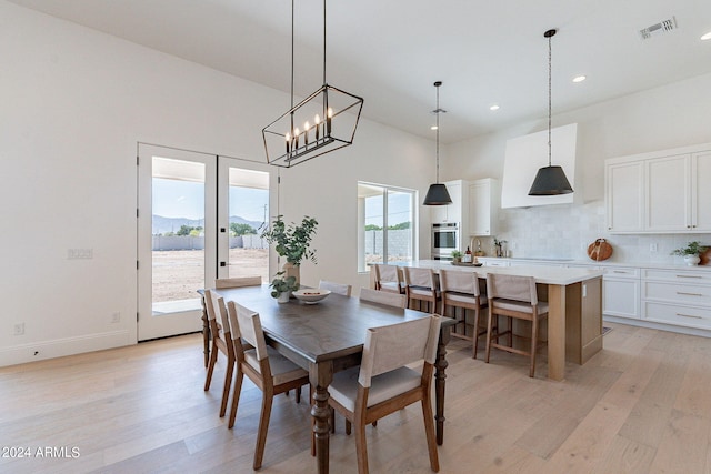 6926 N 177th Pl, Waddell, AZ 85355 - dining space with light wood-style floors, a high ceiling, recessed lighting, a chandelier, and baseboards