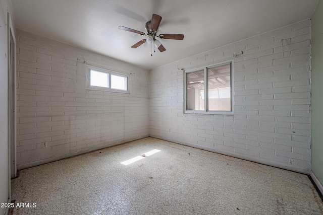 1614 S 6th Ave, Phoenix, AZ 85003 - spare room featuring brick wall and a ceiling fan