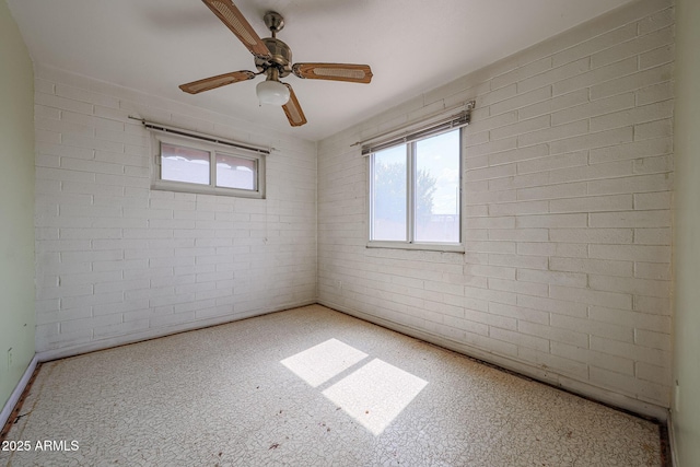 1614 S 6th Ave, Phoenix, AZ 85003 - spare room featuring ceiling fan and brick wall