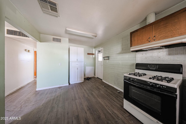 1614 S 6th Ave, Phoenix, AZ 85003 - kitchen featuring range with gas stovetop, dark wood-type flooring, baseboards, and brick wall