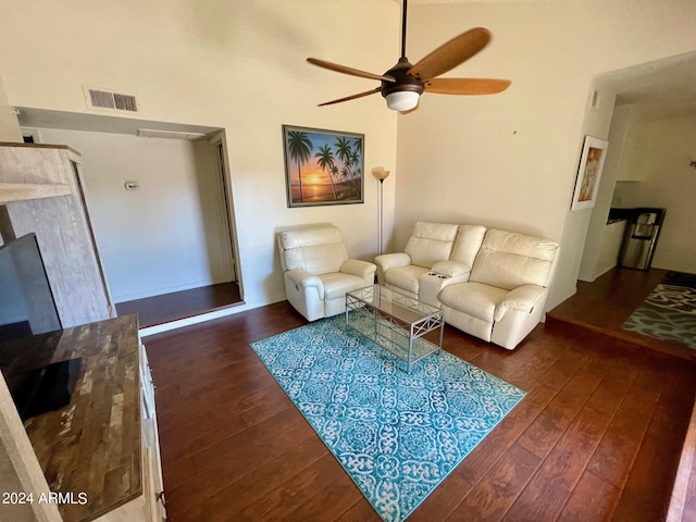 living room featuring ceiling fan and dark hardwood / wood-style floors