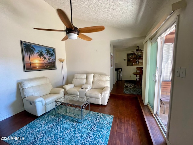 living room featuring dark wood-type flooring and a textured ceiling