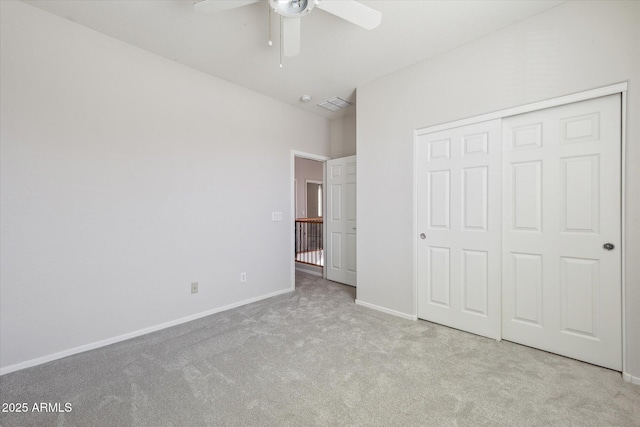 unfurnished bedroom featuring a closet, ceiling fan, and light colored carpet