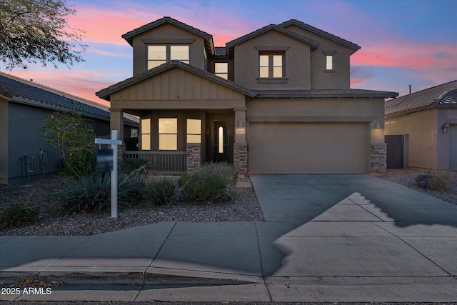 view of front of home with covered porch and a garage