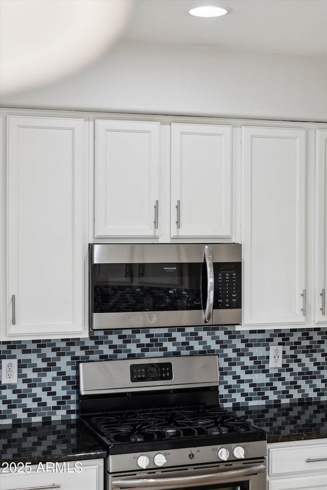 kitchen with white cabinets, backsplash, and stainless steel appliances