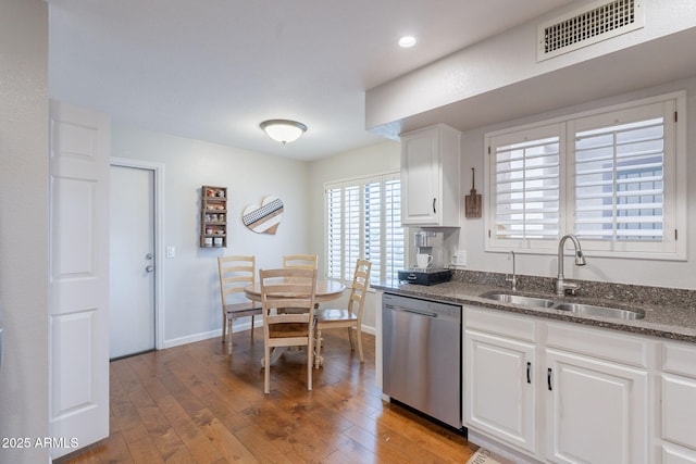 9128 W Kimberly Way, Peoria, AZ 85382 - kitchen with stainless steel dishwasher, a sink, light wood-type flooring, white cabinetry, and dark stone countertops