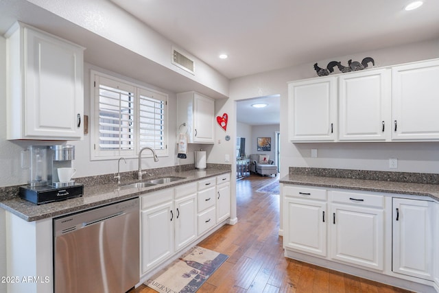 9128 W Kimberly Way, Peoria, AZ 85382 - kitchen featuring stainless steel dishwasher, a sink, white cabinetry, light wood finished floors, and recessed lighting