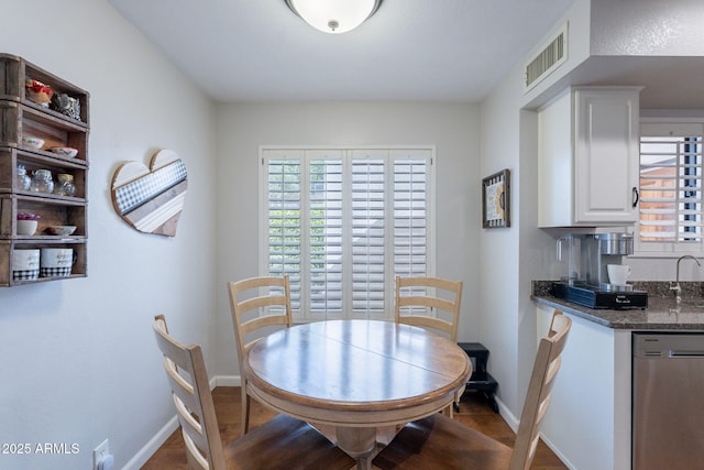 9128 W Kimberly Way, Peoria, AZ 85382 - dining area featuring baseboards, wood finished floors, and bar with sink