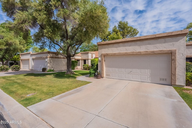 9128 W Kimberly Way, Peoria, AZ 85382 - view of front of house featuring a front yard, stucco siding, a garage, and concrete driveway
