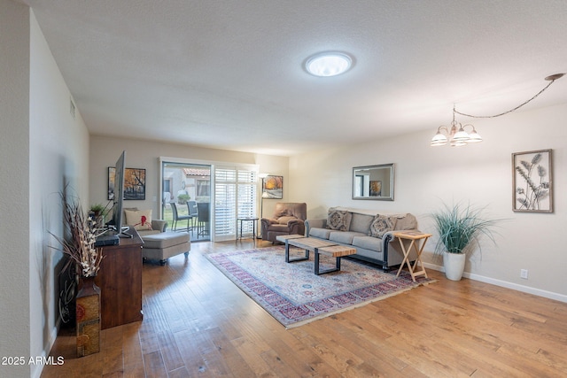 9128 W Kimberly Way, Peoria, AZ 85382 - living room with wood finished floors, a chandelier, and baseboards