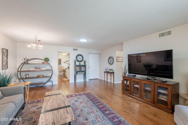 9128 W Kimberly Way, Peoria, AZ 85382 - living area featuring wood finished floors, a chandelier, and baseboards