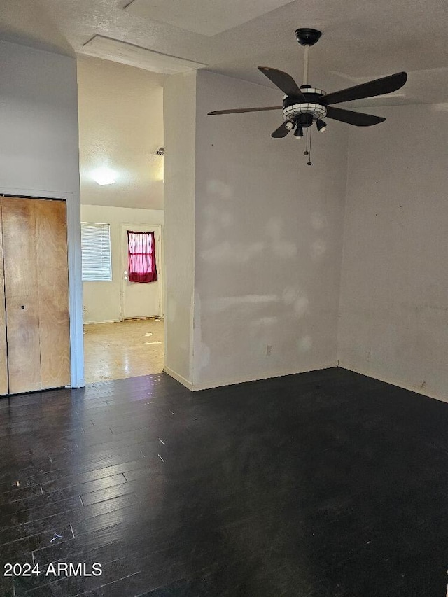 spare room with ceiling fan, wood-type flooring, and a textured ceiling