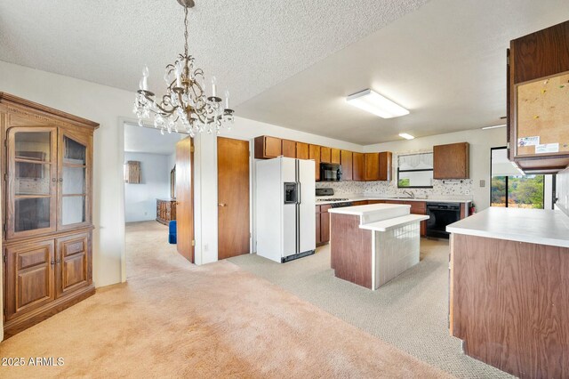 2235 W Mendiburo Way, Prescott, AZ 86305 - kitchen with light countertops, a kitchen island, light carpet, black appliances, and brown cabinets