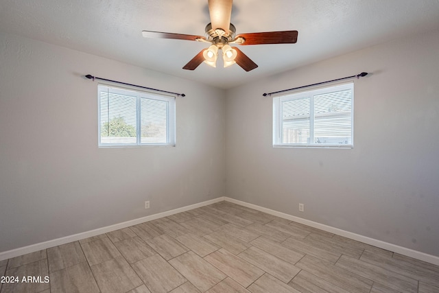 spare room with ceiling fan