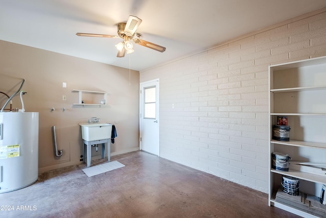 interior space featuring ceiling fan, concrete floors, brick wall, and water heater