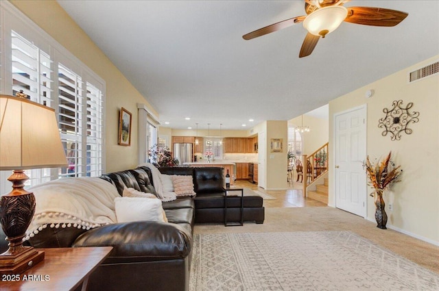 carpeted living room with ceiling fan