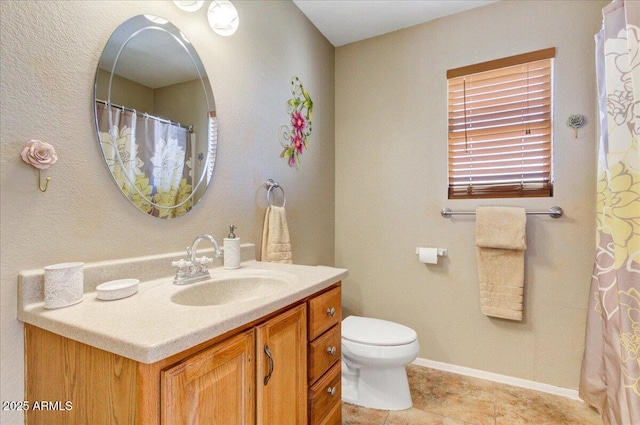 bathroom featuring toilet, vanity, and tile patterned flooring