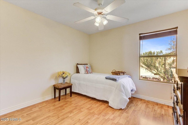 bedroom with light wood-type flooring and ceiling fan