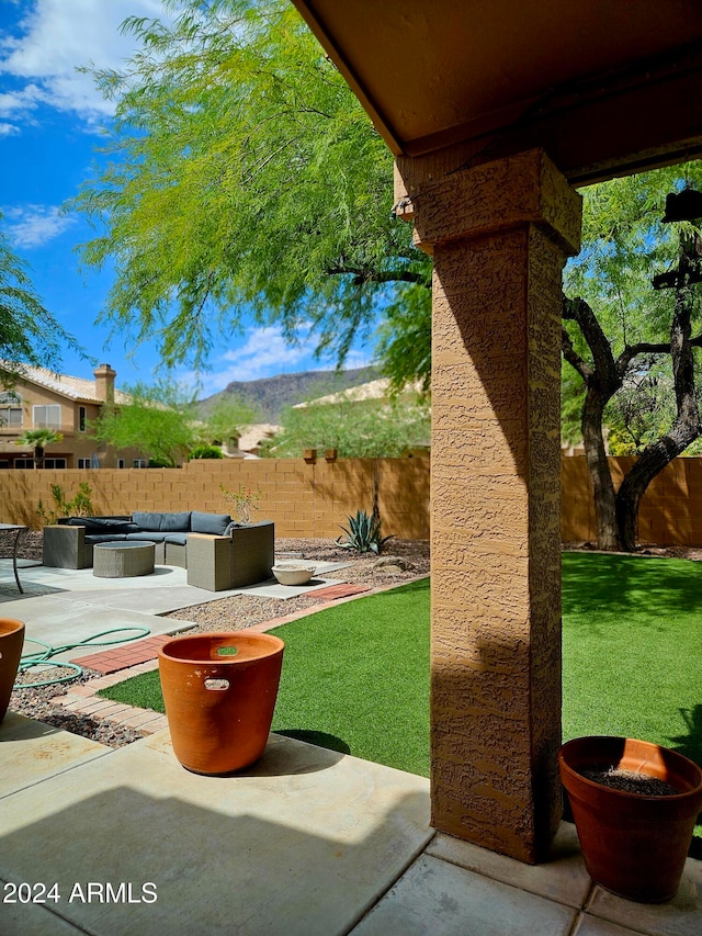 view of yard with a mountain view, outdoor lounge area, and a patio area