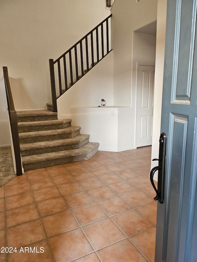 stairs featuring tile patterned flooring