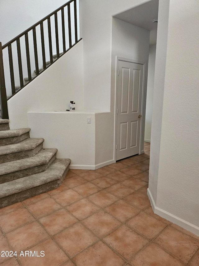 stairs featuring tile patterned floors