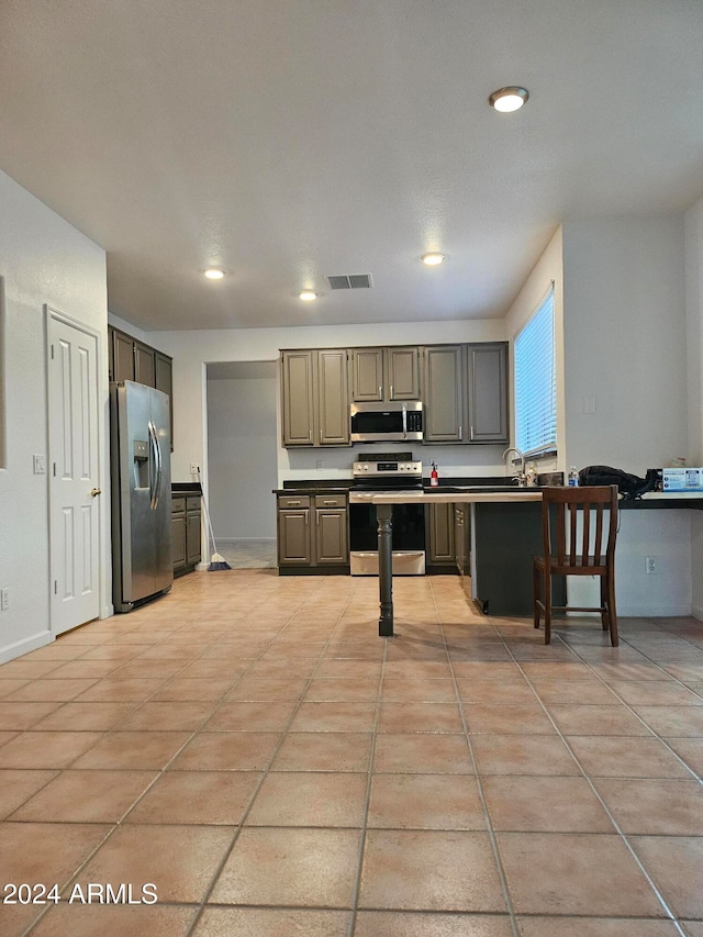 kitchen with gray cabinetry and stainless steel appliances