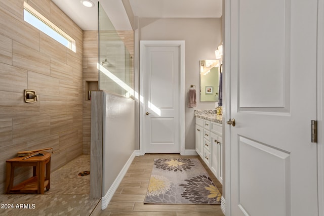 bathroom featuring vanity and a tile shower