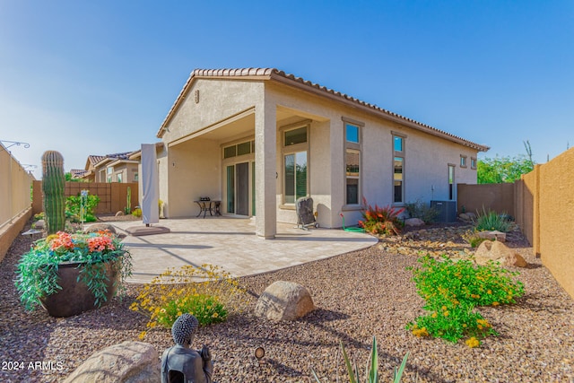 rear view of house with a patio and central air condition unit