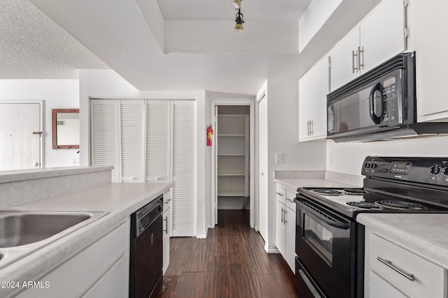 kitchen with dark wood-type flooring, a textured ceiling, black appliances, white cabinetry, and sink