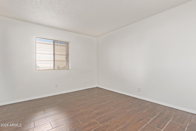 unfurnished room featuring a textured ceiling