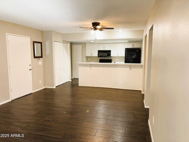 1920 W Lindner Ave Unit 137, Mesa, AZ 85202 - unfurnished living room featuring ceiling fan, dark wood finished floors, a textured ceiling, and baseboards