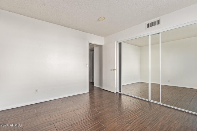 unfurnished bedroom featuring a closet and a textured ceiling