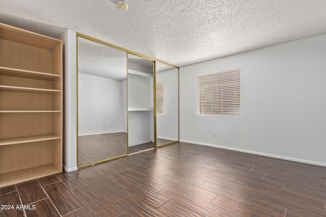 unfurnished bedroom with a textured ceiling and a closet