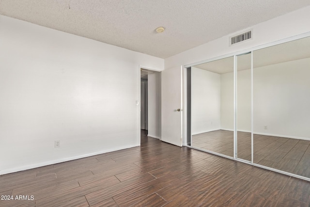1920 W Lindner Ave Unit 137, Mesa, AZ 85202 - unfurnished bedroom with wood finished floors, baseboards, a closet, and a textured ceiling