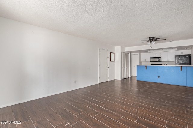 unfurnished living room featuring a textured ceiling and ceiling fan