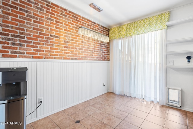 unfurnished room with brick wall