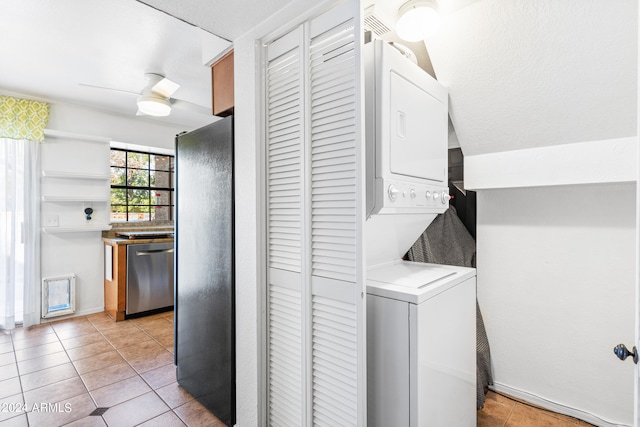 laundry area with stacked washer and clothes dryer, light tile patterned floors, and ceiling fan