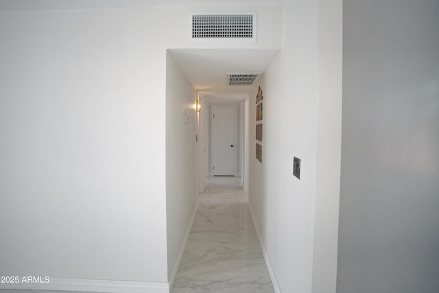 hallway with marble finish floor, visible vents, and baseboards