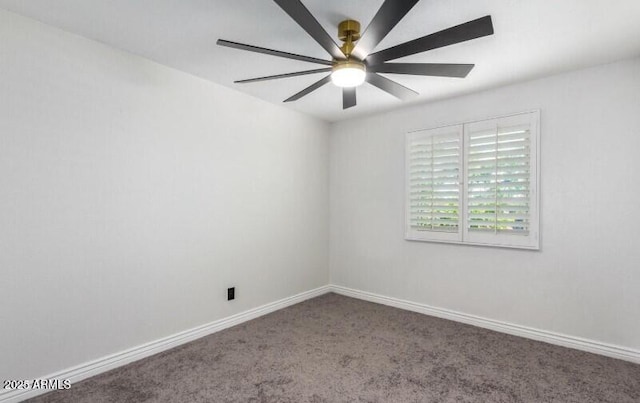 carpeted empty room with ceiling fan and baseboards