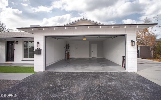 garage with aphalt driveway