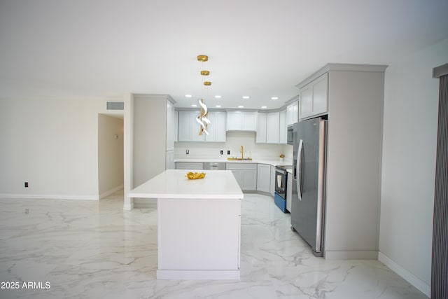 kitchen with appliances with stainless steel finishes, marble finish floor, visible vents, and a sink