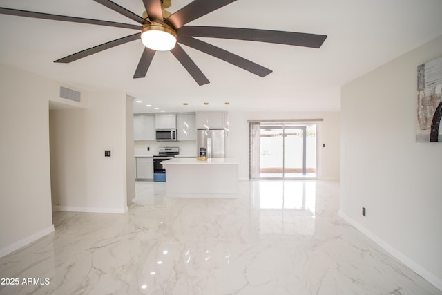 unfurnished living room featuring a ceiling fan, recessed lighting, marble finish floor, and baseboards