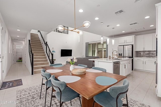 tiled dining room featuring sink