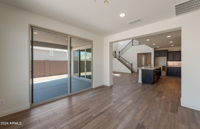 unfurnished living room featuring hardwood / wood-style flooring