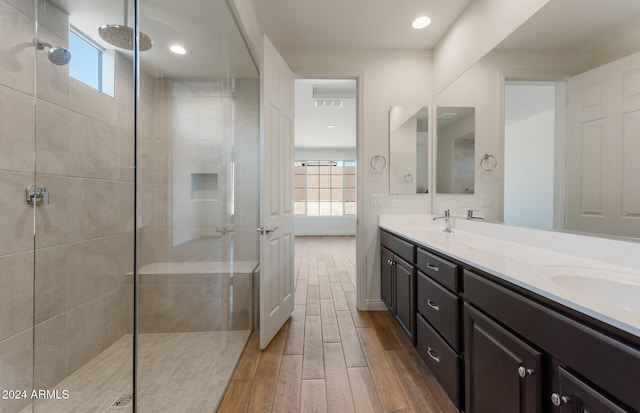 bathroom featuring vanity and tiled shower