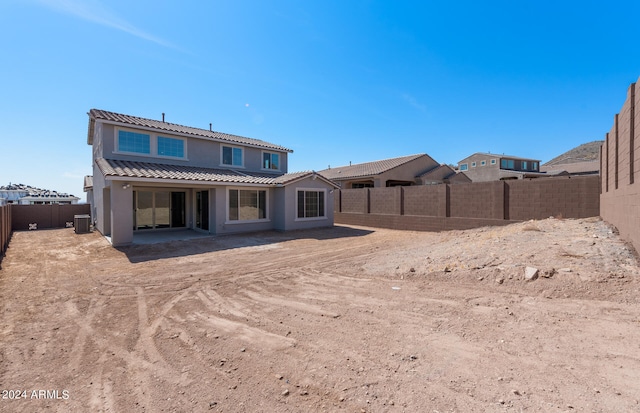 rear view of house featuring a patio area and cooling unit